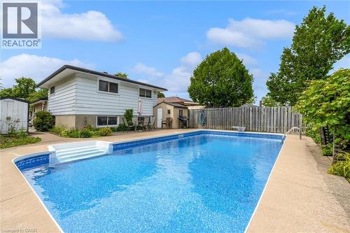 Rectangular inground swimming pool with integrated steps, surrounded by a concrete deck - 7506 Jubilee Drive, Niagara Falls, ON 