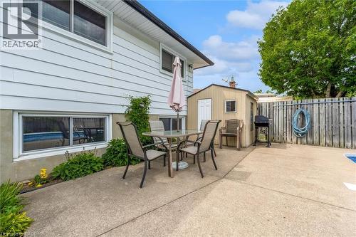 Concrete patio area featuring white siding and a built-in storage shed - 7506 Jubilee Drive, Niagara Falls, ON 
