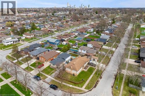 Aerial view of the neighborhood showcasing tree-lined streets, residential properties with green lawns, and a distant city skyline - 7506 Jubilee Drive, Niagara Falls, ON 