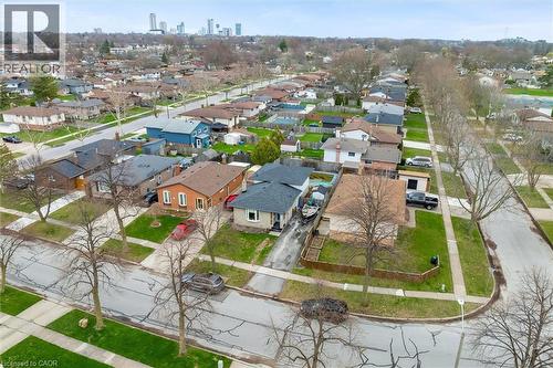 This aerial view showcases a residential street lined with houses and mature trees - 7506 Jubilee Drive, Niagara Falls, ON 