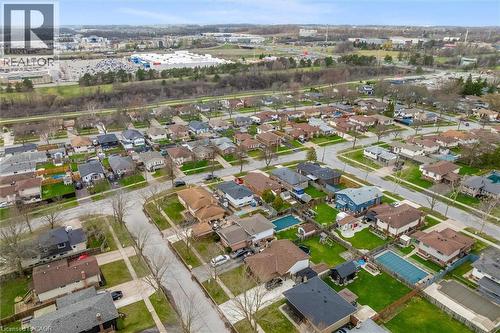 This aerial view showcases the residential area with a variety of properties, many featuring green lawns and mature trees - 7506 Jubilee Drive, Niagara Falls, ON 