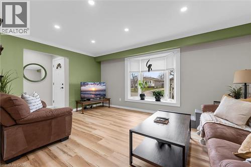 Bright living area featuring light wood flooring, a bay window with blinds, and recessed lighting - 7506 Jubilee Drive, Niagara Falls, ON 