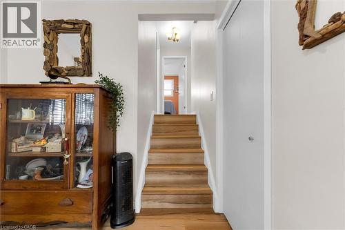 Hardwood stairs with a white railing leading to an upper level - 7506 Jubilee Drive, Niagara Falls, ON 