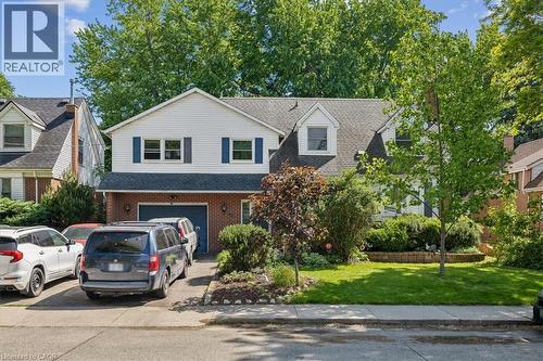 Two-story residence featuring a brick and siding exterior, an attached two-car garage, and a concrete driveway - 80 Maclennan Avenue, Hamilton, ON 