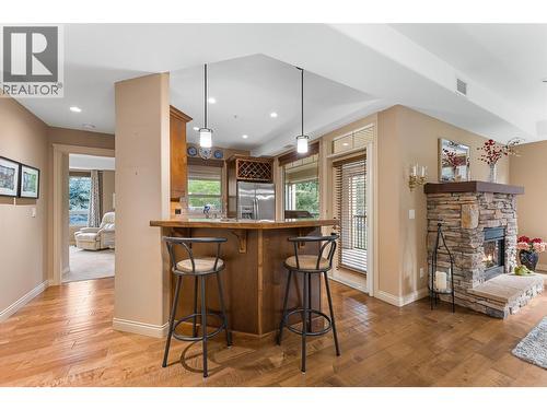Hand-scraped engineered hardwood flooring. AI enhanced flames. - 2780 Auburn Road Unit# 203, West Kelowna, BC 