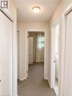 Recessed ceiling light fixture illuminating the carpeted hallway - 