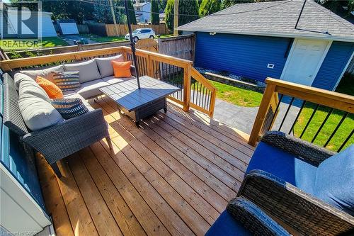 Expansive wood deck with wood railings and black balusters - 19 Thorndale Avenue, St. Catharines, ON 