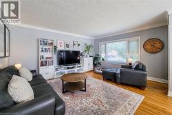 Hardwood flooring, crown molding, white trim, and built-in shelving - 