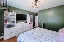Wood-finish flooring with a multi-light ceiling fixture - 