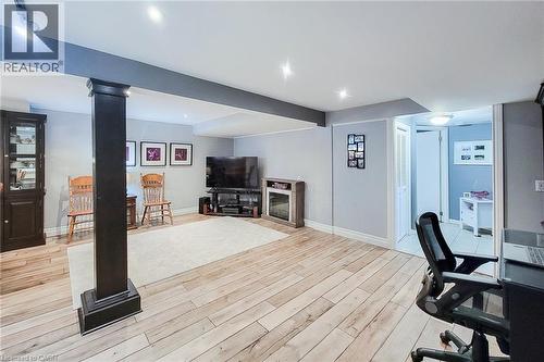 Spacious room with wood-finish flooring, recessed lighting, and a neutral color palette - 19 Thorndale Avenue, St. Catharines, ON 