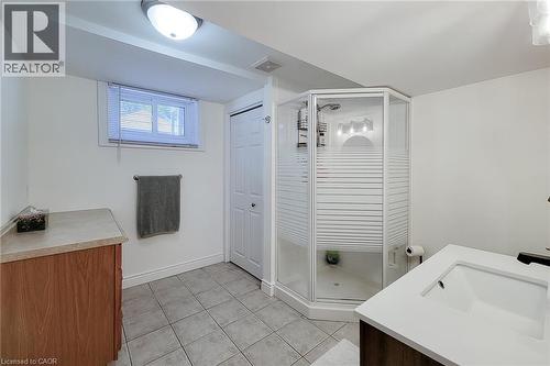 White-finish vanity with an integrated sink and dark-finish faucet - 19 Thorndale Avenue, St. Catharines, ON 