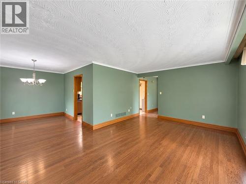 Hardwood flooring, painted walls, crown molding, and a chandelier - 2490 Yarmouth Crescent, Oakville, ON 