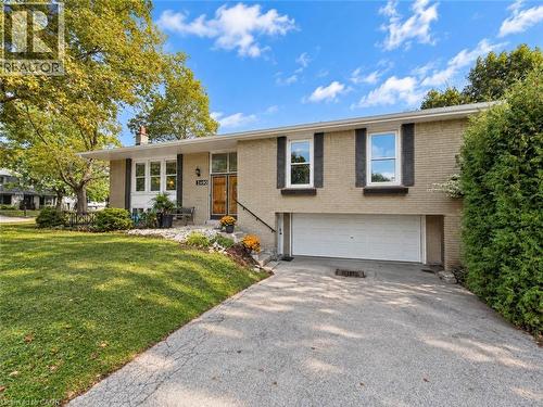 Brick exterior with white window frames and dark shutters - 2490 Yarmouth Crescent, Oakville, ON 