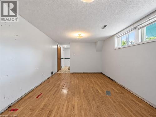 Wood-finish flooring with white walls and a white textured ceiling - 2490 Yarmouth Crescent, Oakville, ON 