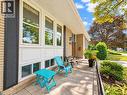 Brick exterior with multiple windows and dark louvered shutters - 2490 Yarmouth Crescent, Oakville, ON 