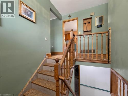 Wood-finish stairs with classic wood balusters and railing - 2490 Yarmouth Crescent, Oakville, ON 
