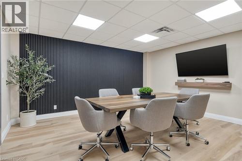 Wood-finish flooring with a contrasting dark accent wall - 23 Market Street W, Port Dover, ON 