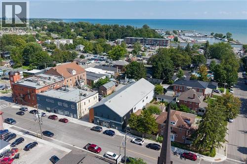 Waterfront community setting with diverse architectural styles, tree-lined streets, and a prominent marina - 23 Market Street W, Port Dover, ON 