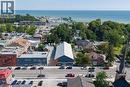 Commercial building with a prominent street-front presence and direct proximity to a body of water and marina - 23 Market Street W, Port Dover, ON 