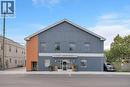 Two-story commercial building featuring a pitched roof and vertical siding - 23 Market Street W, Port Dover, ON 