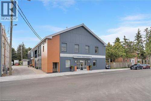 Modern multi-story facade featuring varied siding and an awning - 23 Market Street W, Port Dover, ON 