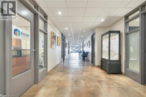 Hallway featuring tiled flooring, recessed lighting, and glass-paneled entry doors - 23 Market Street W, Port Dover, ON 