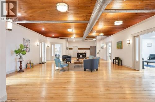 Exposed wood ceiling with recessed lighting, light wood-finish flooring, and white walls - 23 Market Street W, Port Dover, ON 
