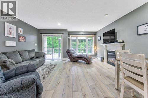 Wood-finish flooring throughout, recessed lighting, and a built-in fireplace with a decorative mantel - 423 Poldon Drive, Norwich, ON 