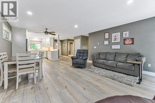 Open-concept living space featuring wood-finish flooring, recessed lighting, and a ceiling fan - 423 Poldon Drive, Norwich, ON 