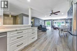 Kitchen featuring white cabinetry, light-colored countertops, and a tile backsplash - 