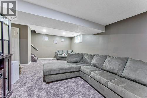 Recessed lighting illuminates the carpeted flooring and painted walls - 423 Poldon Drive, Norwich, ON 