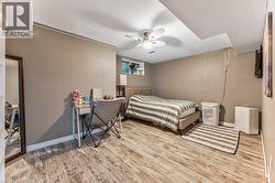 Wood-finish flooring, neutral wall tones, recessed ceiling, and a ceiling fan - 
