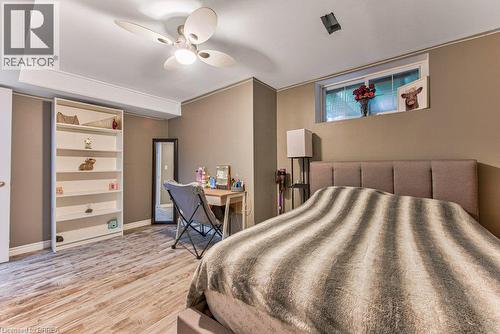 Wood-finish flooring, recessed lighting, ceiling fan, built-in shelving, and a horizontal window - 423 Poldon Drive, Norwich, ON 