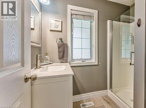 White vanity with integrated sink, brushed nickel faucet, and quartz countertop - 423 Poldon Drive, Norwich, ON 