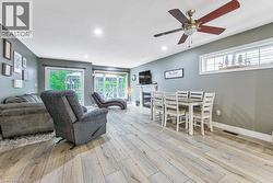 Wood-finish flooring, recessed lighting, and a ceiling fan with integrated light - 