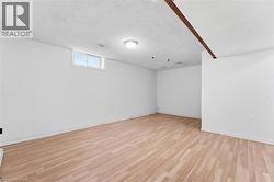 Recessed window, wood-finish flooring, ceiling-mounted light fixture, exposed wood beam - 