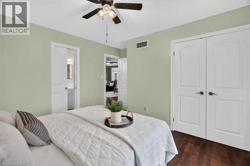 Hardwood-finish flooring, ceiling fan, and light green wall finish - 515 Woodward Drive, Mount Brydges, ON 