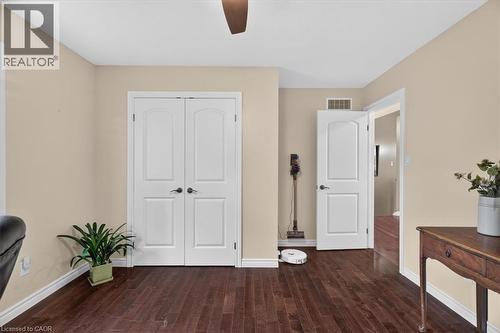 Rich wood-finish flooring with white trim - 515 Woodward Drive, Mount Brydges, ON 