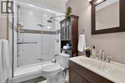 Glass-enclosed shower with tile surround and rain showerhead - 