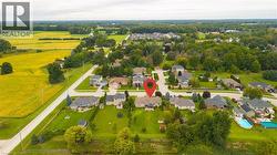 Aerial perspective of a residential neighborhood with mature trees, established homes, and green spaces - 