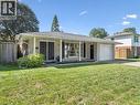 Brick exterior with an attached single-car garage, covered front porch, and mature landscaping - 35 Crosby Drive, Kitchener, ON 