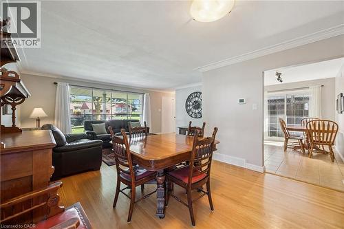 Hardwood flooring extending into the living area, large picture window, and crown molding - 35 Crosby Drive, Kitchener, ON 