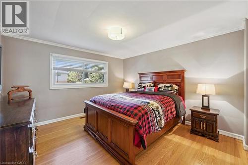 Hardwood flooring, painted walls, crown molding, white window trim, and a flush mount ceiling light - 35 Crosby Drive, Kitchener, ON 