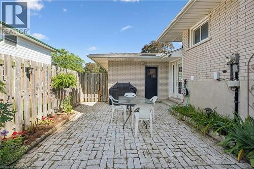 Brick paver patio with perimeter landscaping and a privacy fence - 35 Crosby Drive, Kitchener, ON 