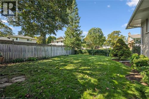Expansive lawn area with mature trees and perimeter fencing - 35 Crosby Drive, Kitchener, ON 