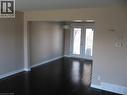 Open concept living room and dining room with french doors leading to rear yard - 124 Avalon Place, Kitchener, ON 