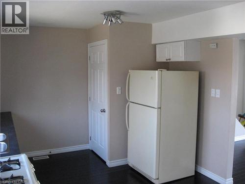 Kitchen featuring white cabinetry and white appliances - 124 Avalon Place, Kitchener, ON 