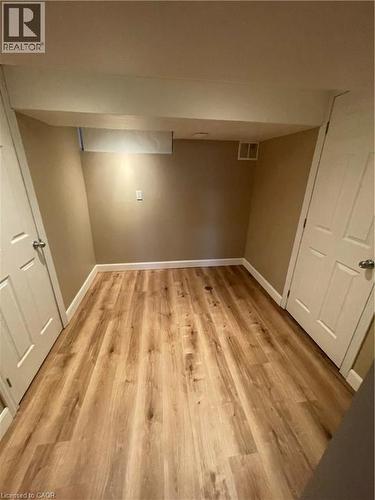 Finished basement with light wood-type flooring - 124 Avalon Place, Kitchener, ON 