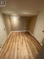 Finished basement with light wood-type flooring - 