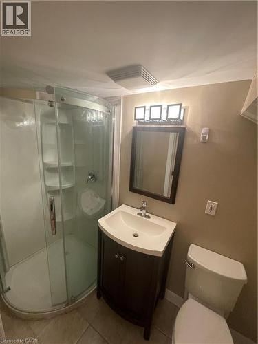 Bathroom featuring vanity, shower stall, and light tile patterned floors - 124 Avalon Place, Kitchener, ON 
